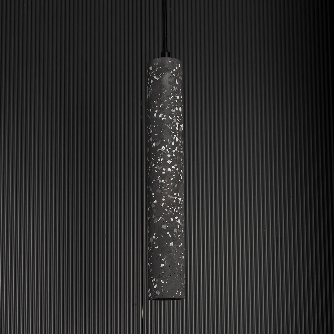 Amber glass pendant light unlit against black background showcasing soft amber tone and reflective finish.
