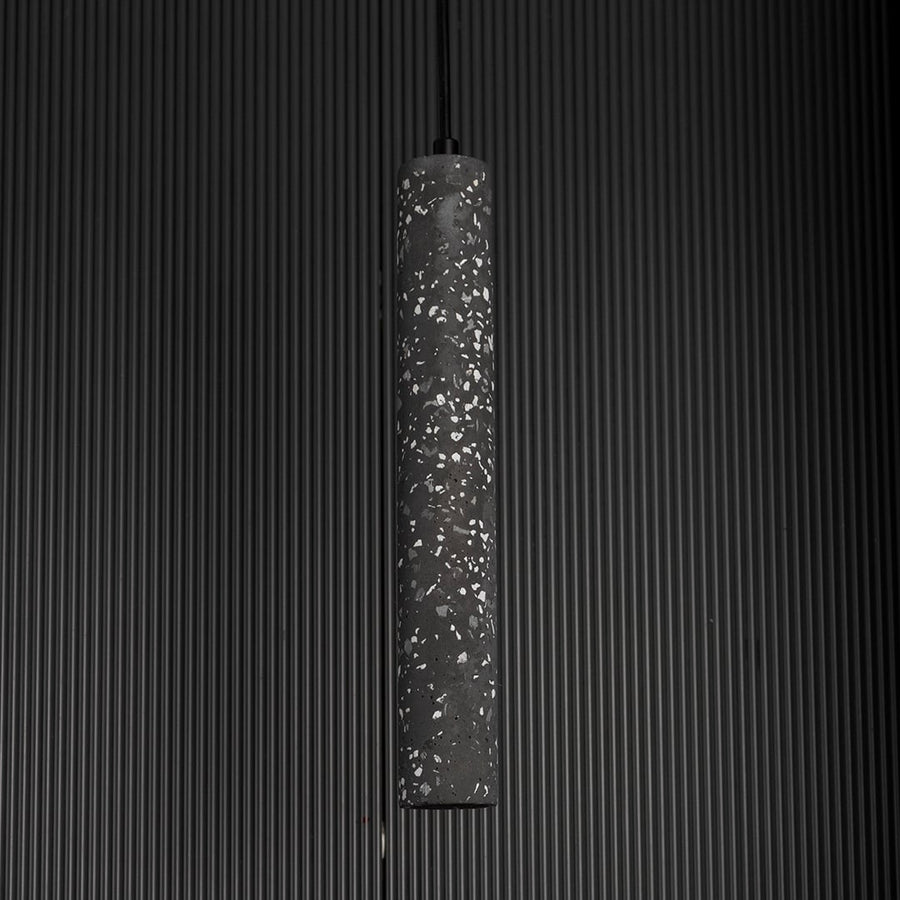 Amber glass pendant light unlit against black background showcasing soft amber tone and reflective finish.