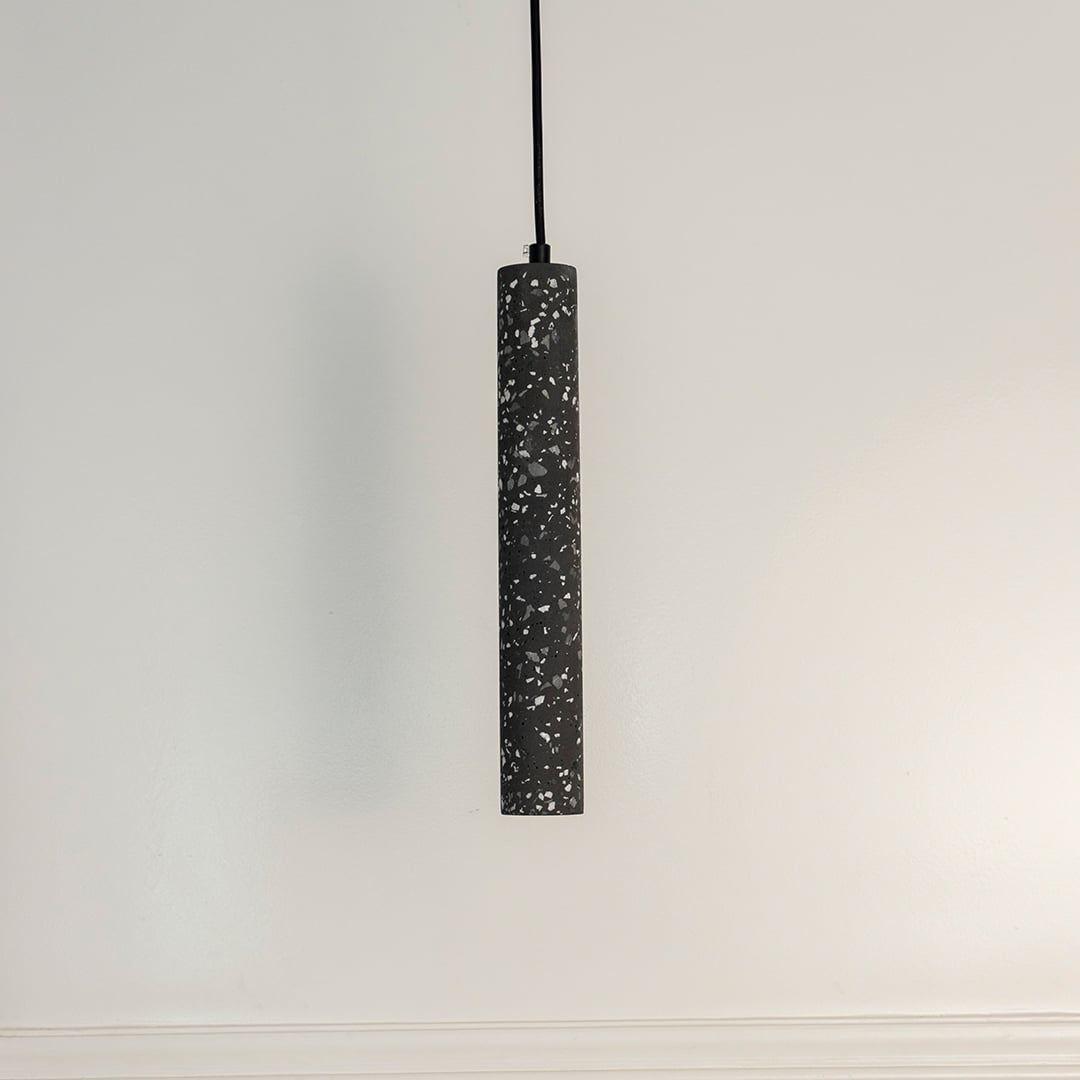 Amber glass pendant light turned off on white background displaying golden amber tint and smooth glass finish.