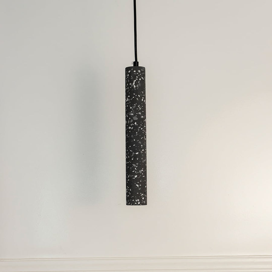 Amber glass pendant light turned off on white background displaying golden amber tint and smooth glass finish.
