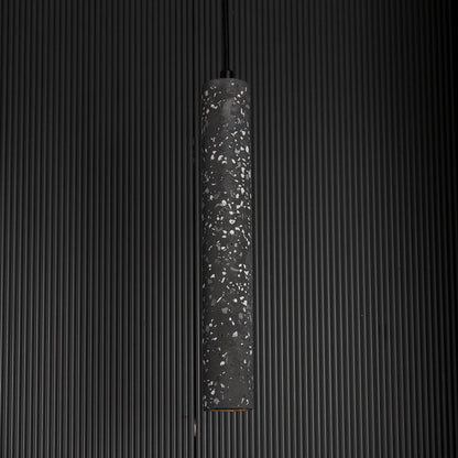 Amber glass pendant light glowing warmly against a dark background highlighting its translucent amber hue.