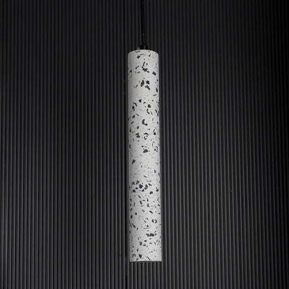 Terrazzo pendant light turned off softly on dark background highlighting fine terrazzo craftsmanship.