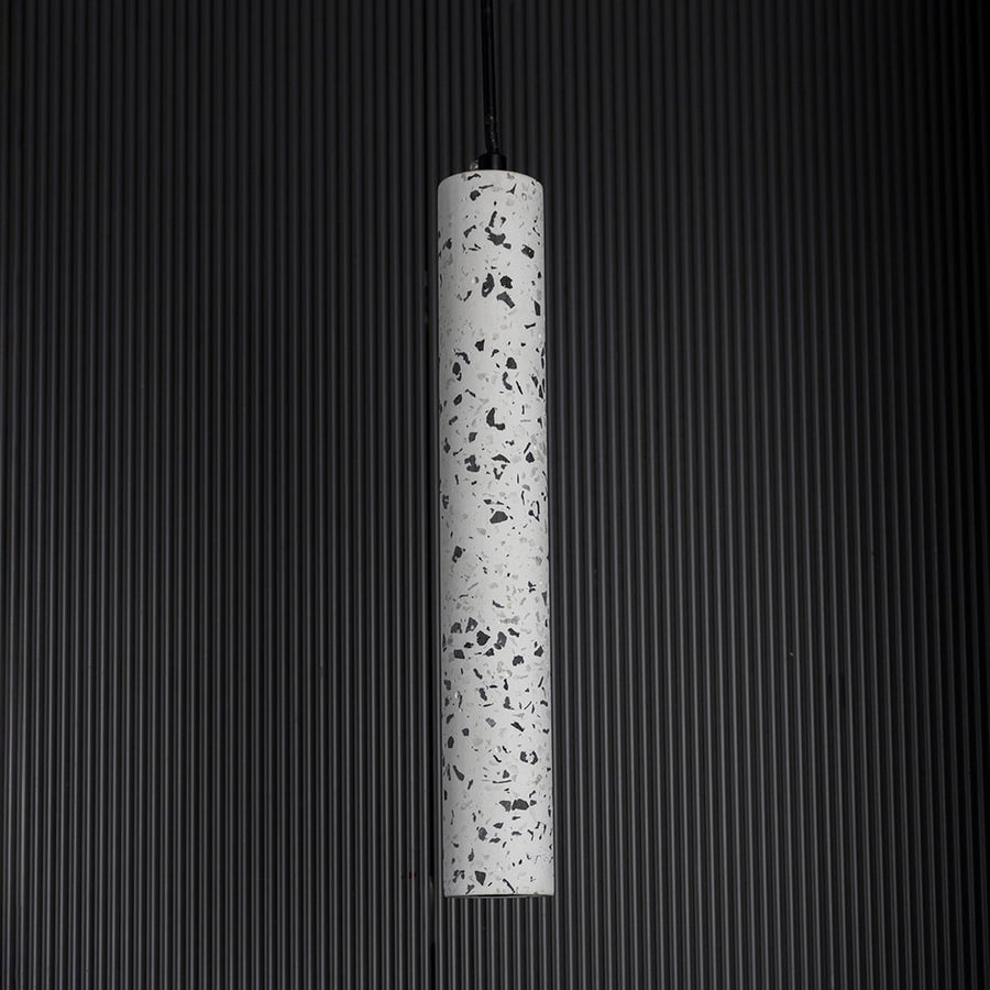 Terrazzo pendant light turned off softly on dark background highlighting fine terrazzo craftsmanship.