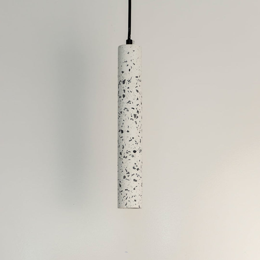 Cylindrical terrazzo pendant light with white stone texture and black accents for stylish interiors.