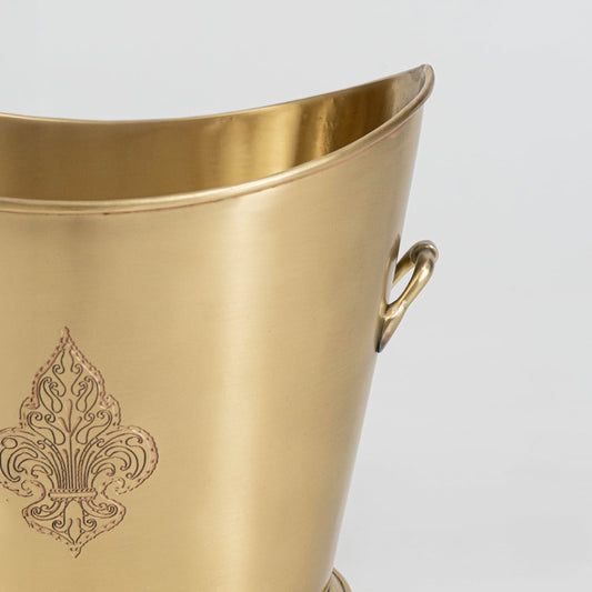 Stylish gold metal planter with embossed design placed on a light background for elegant room styling.