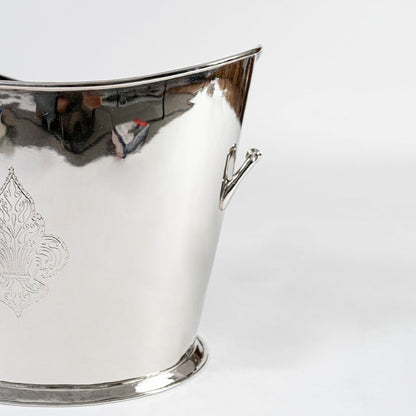 Ornate gold brass planter with floral engraving and dual handles placed on a plain white background.