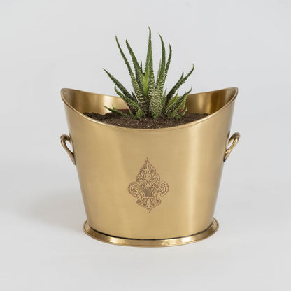 Gold metal decorative planter with twin side handles and embossed pattern on plain white background display.