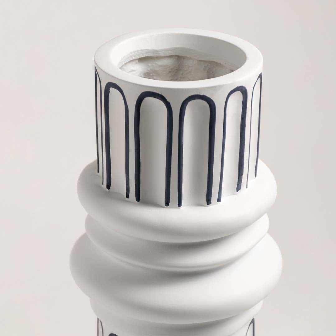 Closeup of white ceramic table lamp base with ribbed detailing showcasing premium craftsmanship and elegant styling.