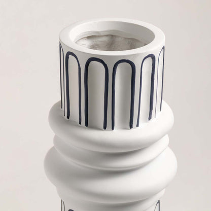 Closeup of white ceramic table lamp base with ribbed detailing showcasing premium craftsmanship and elegant styling.