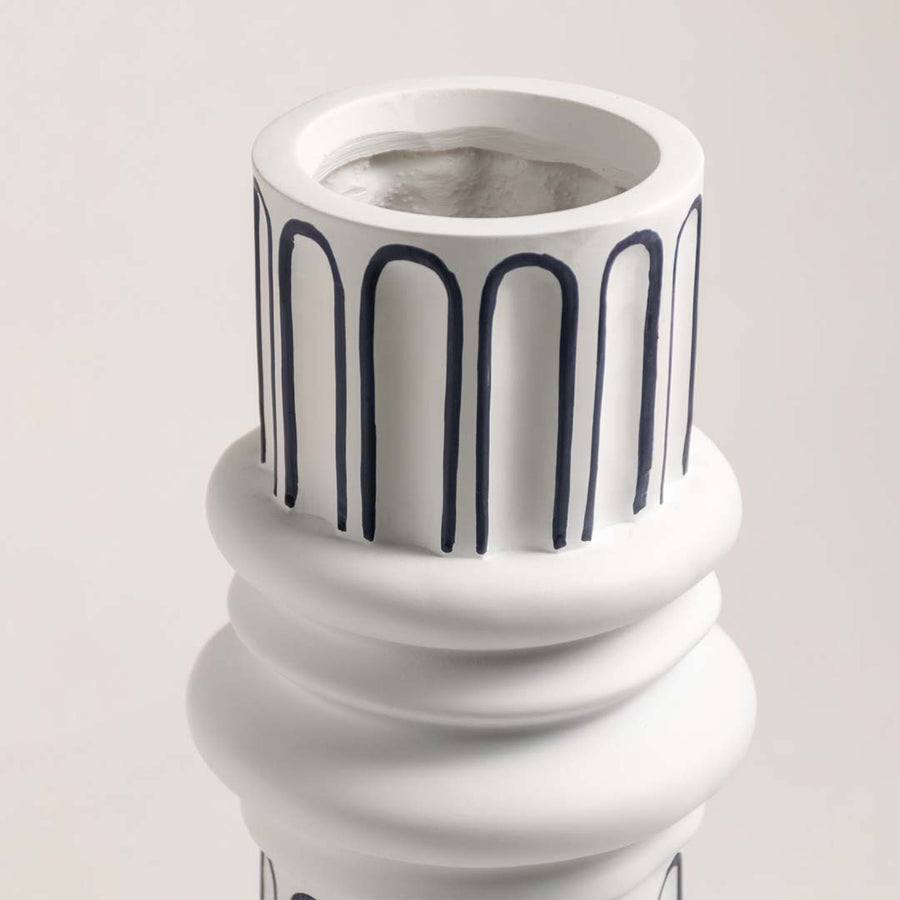 Closeup of white ceramic table lamp base with ribbed detailing showcasing premium craftsmanship and elegant styling.