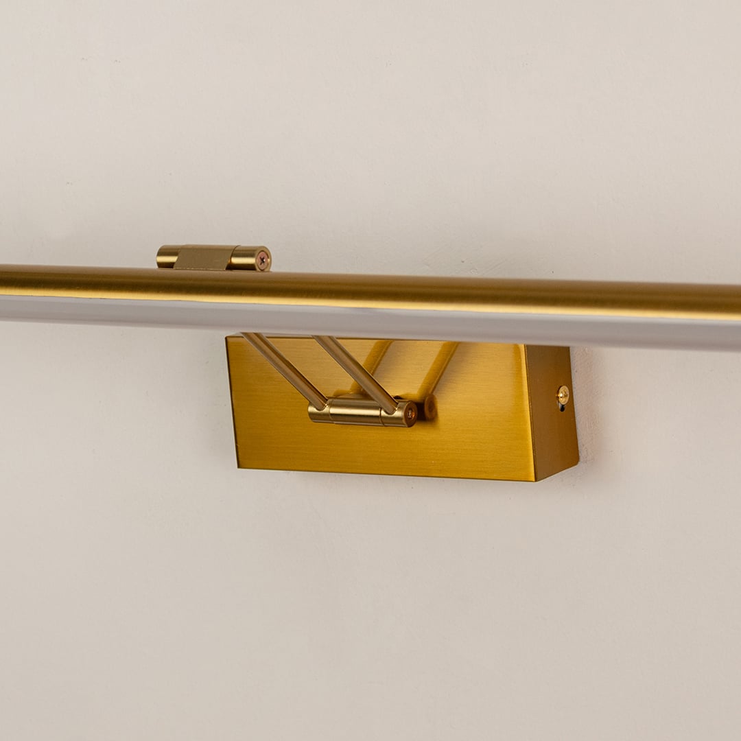 Closeup of gold picture light showcasing sleek metal body and warm LED glow for refined wall decor lighting.