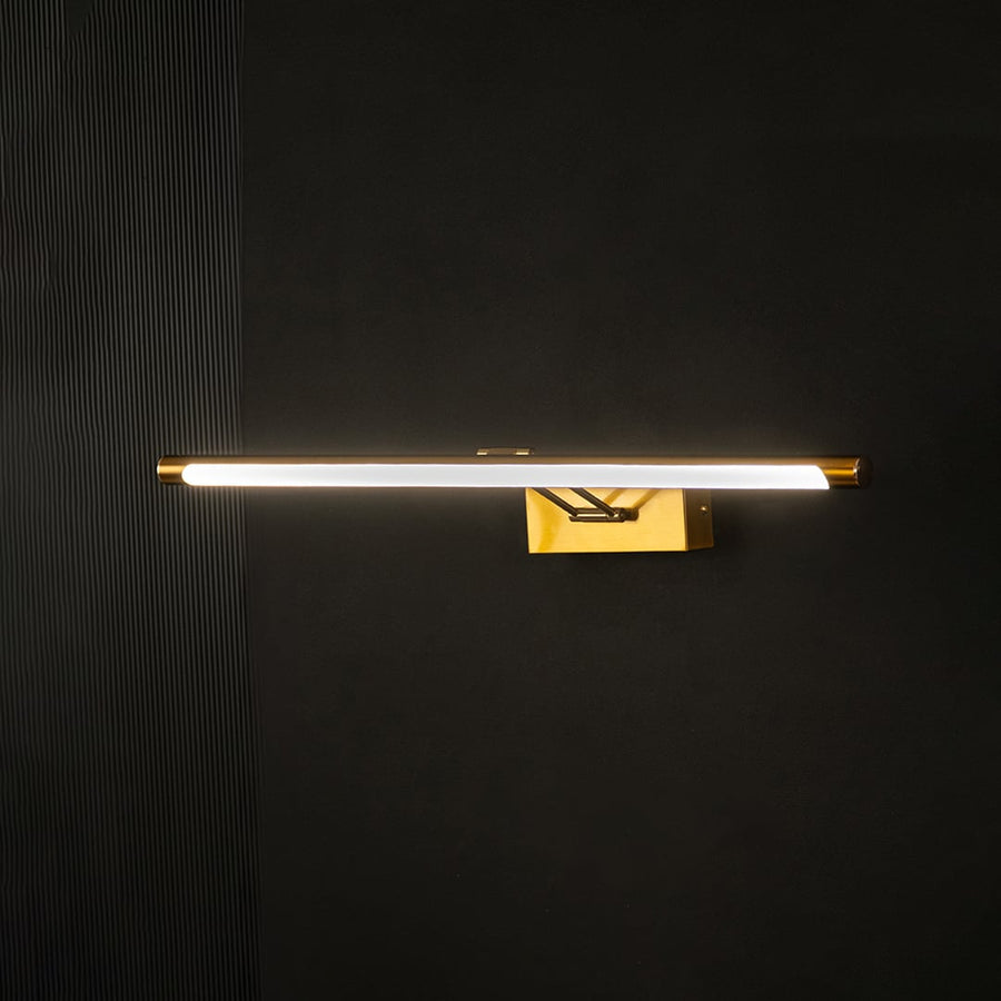 Gold picture light glowing warmly against black background creating a rich modern accent for elegant interiors.