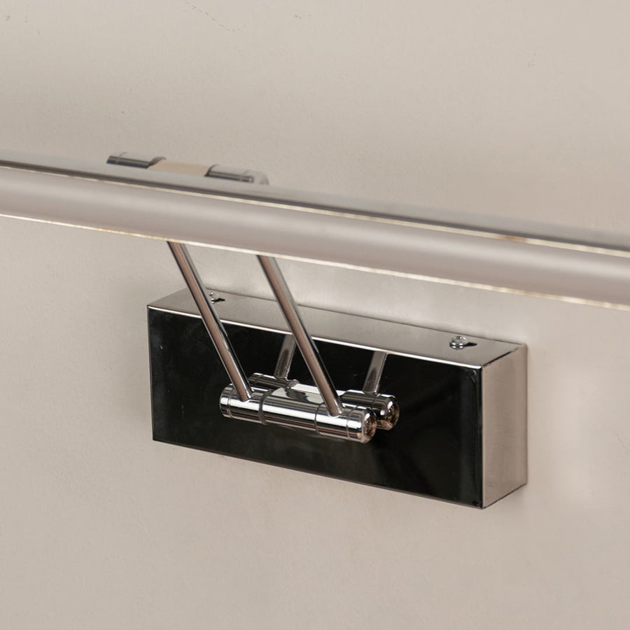 Closeup of chrome picture light showing sleek bar design and warm LED glow for premium wall mounted picture lighting.
