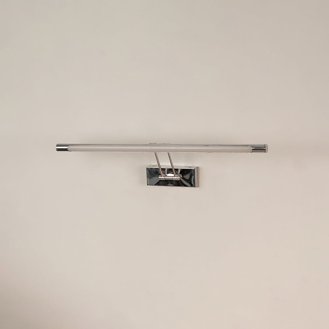 Chrome picture light with LED bar switched off on white background showcasing modern wall decor lighting design.