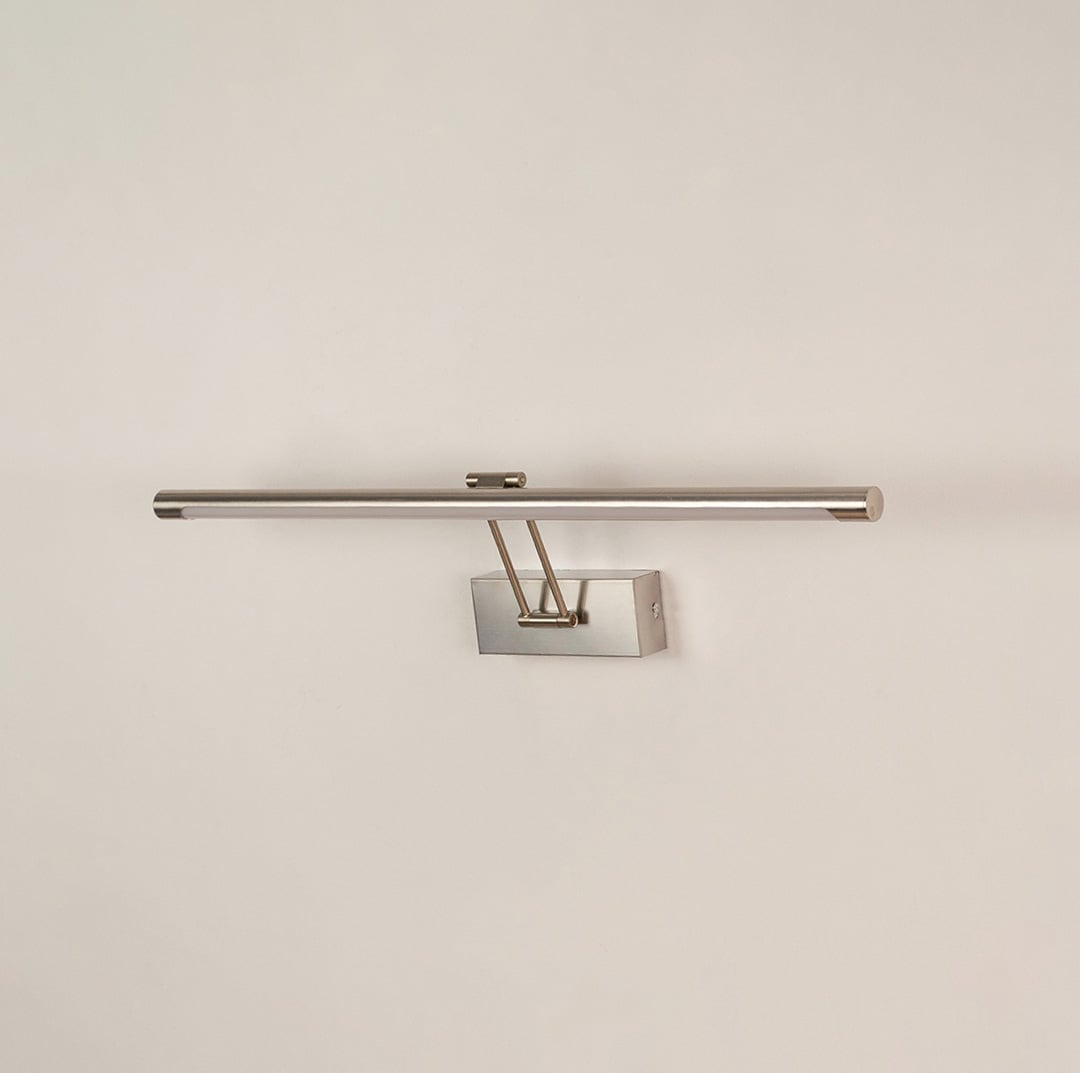 Silver picture light displayed on white background with light off showing clean metal finish and contemporary wall mounting style.