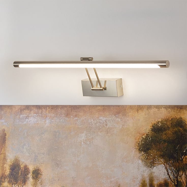 Lifestyle closeup of silver picture light showing fine metal detailing and adjustable arm for precise picture illumination.