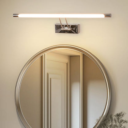 Lifestyle closeup of chrome picture light illuminating artwork with warm LED glow for elegant picture frame wall lighting.