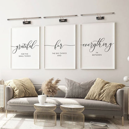 Elegant chrome picture light glowing softly on a neutral wall perfect for modern living room and gallery style home lighting.