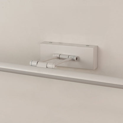 Closeup of white adjustable picture light showing sleek metal body and smooth modern wall mounted design.