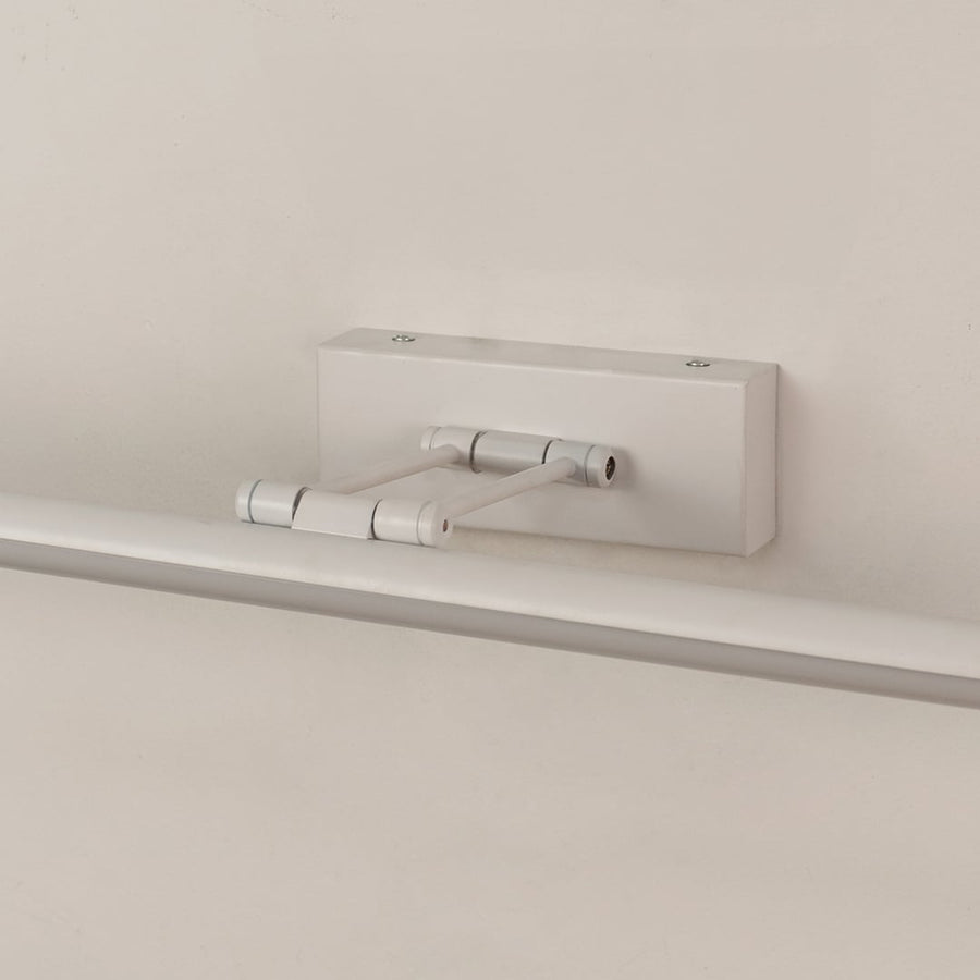Closeup of white adjustable picture light showing sleek metal body and smooth modern wall mounted design.