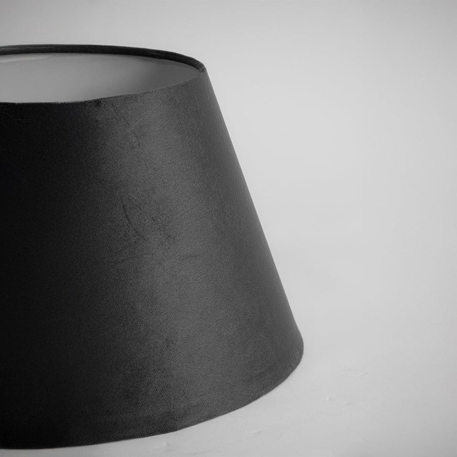 Closeup view of the black tapered lampshade showing the rich fabric texture and smooth finish on a white background for a clear detailed product presentation.