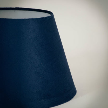 Closeup view of the blue tapered lampshade showing its rich fabric texture and precise finish for a clear detailed product presentation.