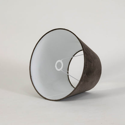 Brown tapered lampshade displayed on a clean white background highlighting its smooth fabric texture and classic wide base shape.