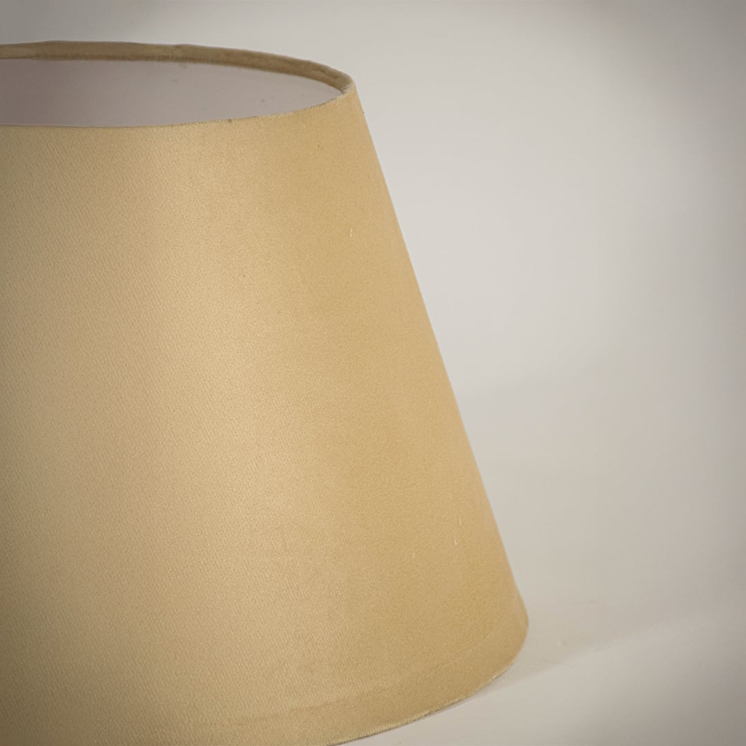 Closeup view of the beige tapered lampshade showing the smooth fabric finish and neat form captured on a white background for a clear detailed presentation.