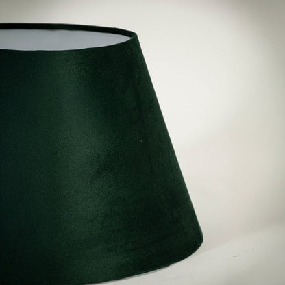 Closeup view of the green tapered lampshade showing its velvet texture and neat detailing for a clear and refined product presentation.