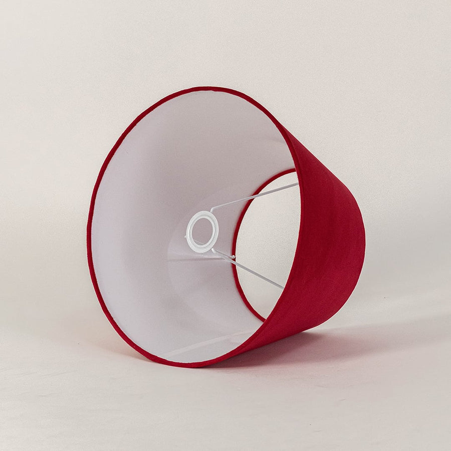 Red tapered lampshade displayed on a clean white background highlighting its smooth fabric texture and wide shape for modern lighting.