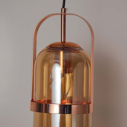Close view of amber glass pendant lamp with gold frame showing fine detailing and premium modern lighting design.