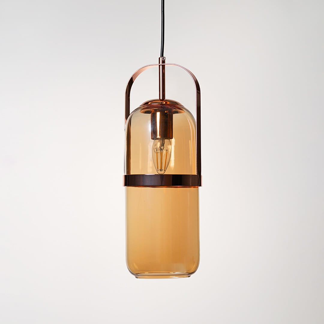 Amber glass pendant lamp in golden frame shown off on plain white background highlights elegant modern design.