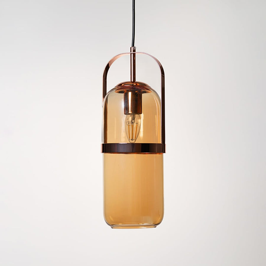 Amber glass pendant lamp in golden frame shown off on plain white background highlights elegant modern design.