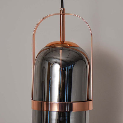 Detailed closeup of smoked glass pendant lamp with copper finish showing fine craftsmanship and texture.
