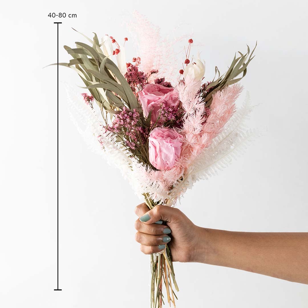 Closeup of Infinity Rose light pink bouquet featuring preserved hydrangea miscanthus eucalyptus and crystal grass is a luxury preserved flower arrangement.