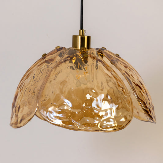Contemporary pendant light in gold metal finish with textured glass shade for dining room or kitchen decor lighting white background.