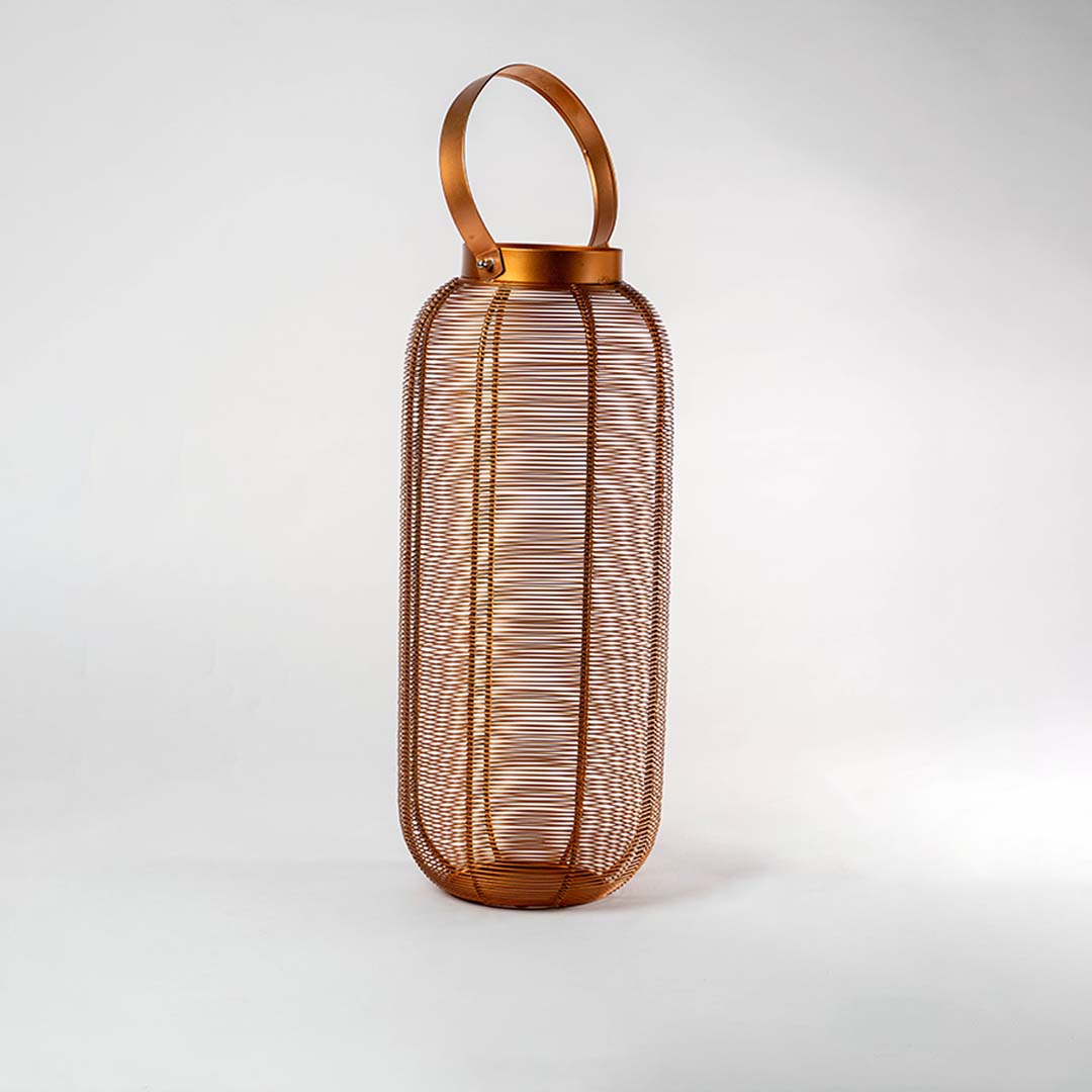 Unlit copper wire lantern featuring a stylish modern design with a handle displayed on a pristine white background ideal for contemporary home decor.