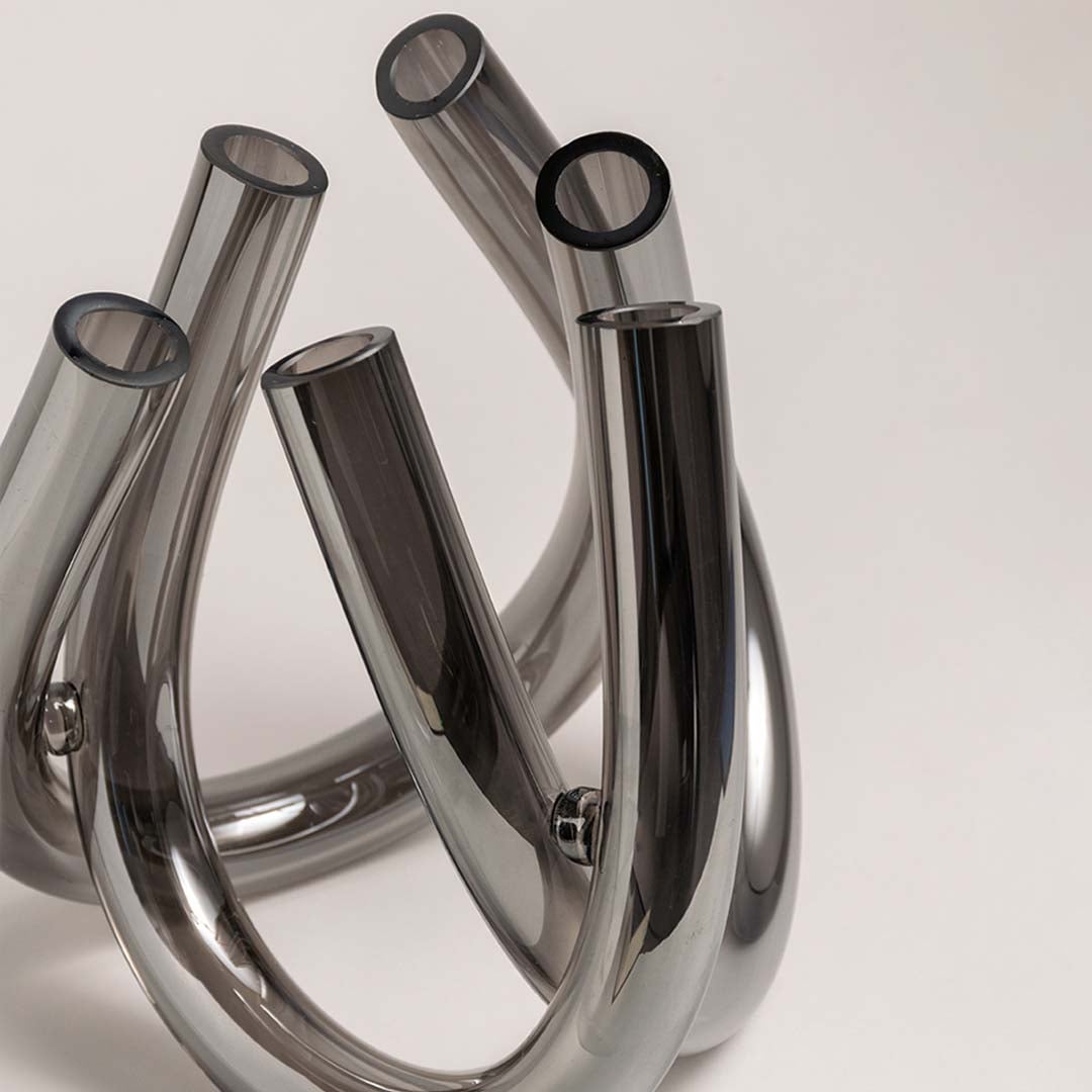 Smoke grey glass decorative vase set with artistic curved silhouettes for elegant contemporary home decor displays.