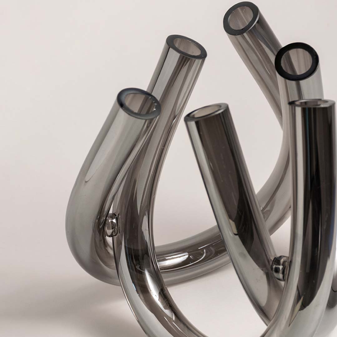 Set of smoke grey glass decorative vases with curved sculptural forms for modern tabletop styling and home decor.