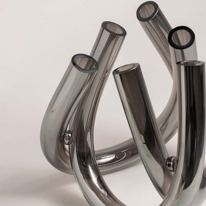 Set of smoke grey glass decorative vases with curved sculptural forms for modern tabletop styling and home decor.