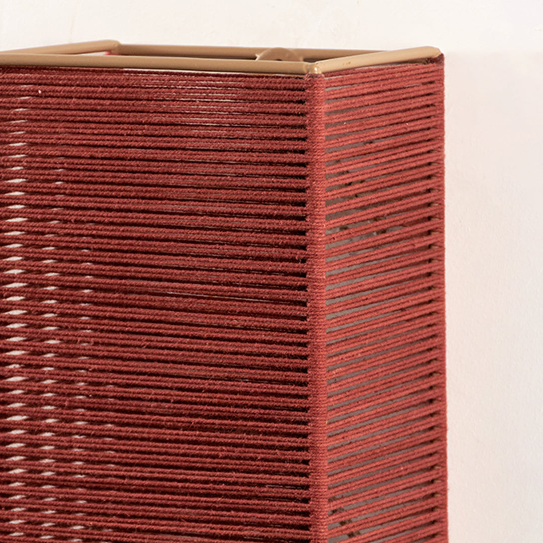 Closeup of red textured wall light highlighting detailed pattern and rich finish for modern interior wall decor styling.