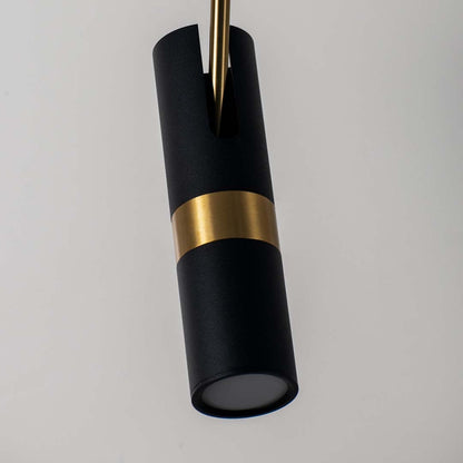 Closeup of modern black and gold cylindrical pendant lamp with matte finish stylish ceiling light for luxury home interiors.