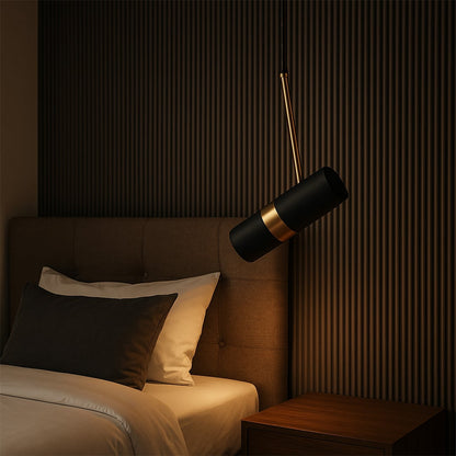 Modern black and gold cylindrical pendant light hanging beside bed elegant bedroom ceiling lamp for luxury home interiors.