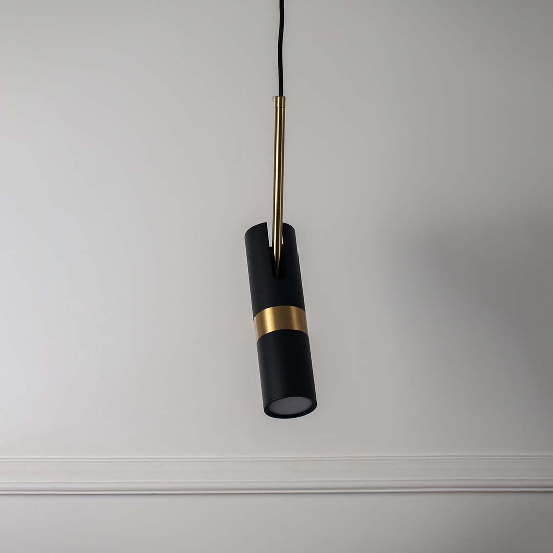 Elegant black and gold cylindrical pendant light with modern design perfect ceiling lamp for living room and dining interiors.