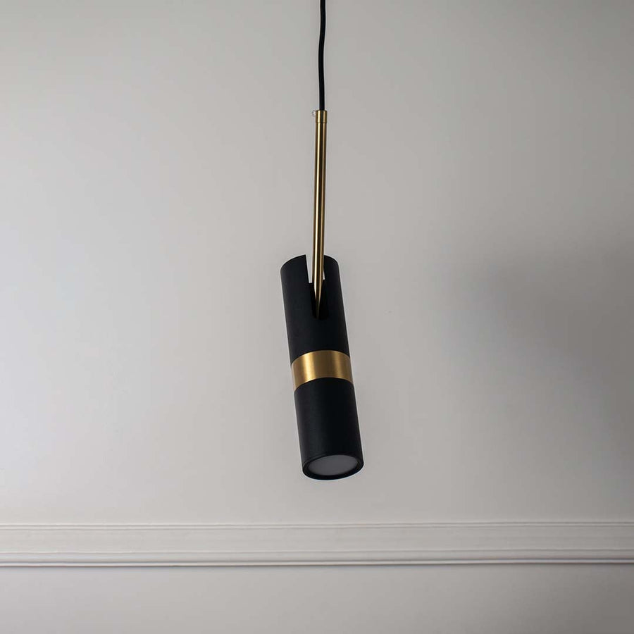 Elegant black and gold cylindrical pendant light with modern design perfect ceiling lamp for living room and dining interiors.