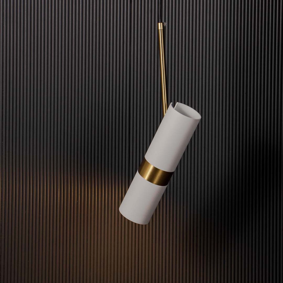 Contemporary white and gold cylindrical pendant lamp glowing warm light elegant ceiling fixture for luxury modern home styling.