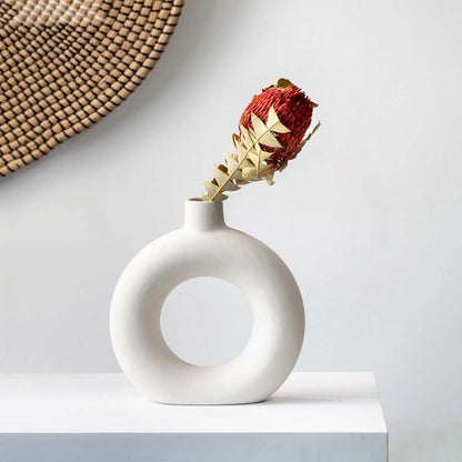 Dried protea stem shown in a natural earthy tone for home decor styling on a clean light setting.