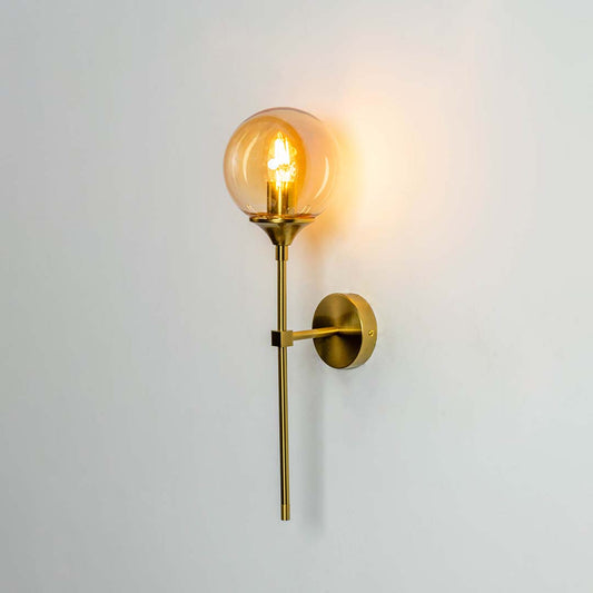 Modern brass wall light with sleek geometric metal frame for elegant contemporary interior decor.