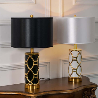 Set of black and gold ceramic table lamps with fabric shades for coordinated luxury home and office decor.