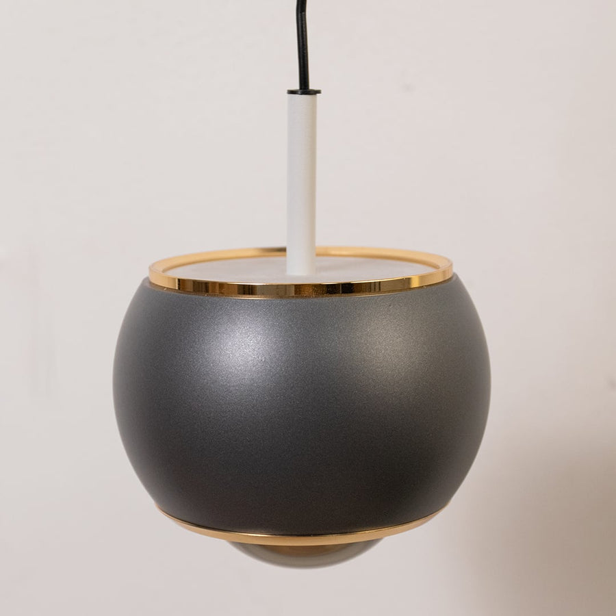 Table lamp look wall light closeup showing the matte black arm and round shade with refined detailing for modern interior lighting decor.
